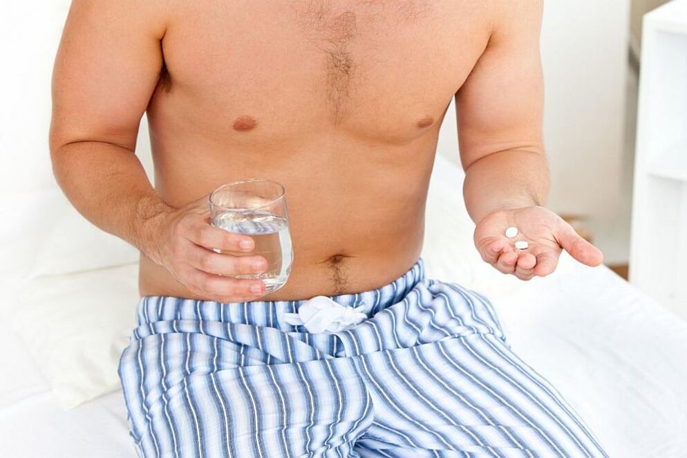 a man takes pills for prostatitis